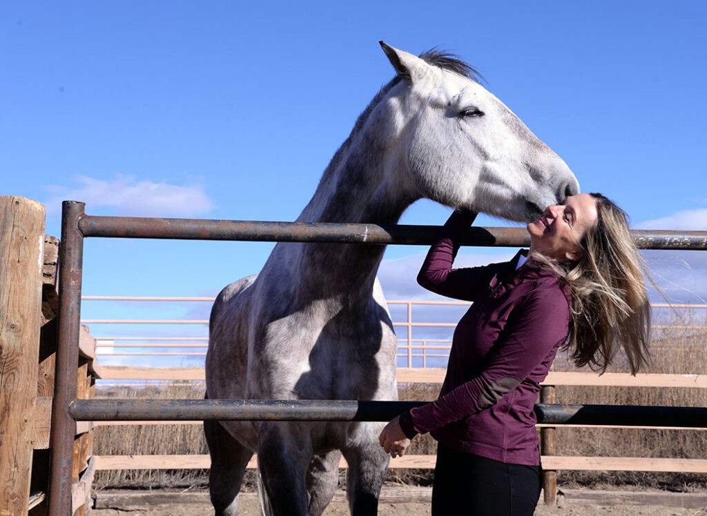 Horse kissing woman